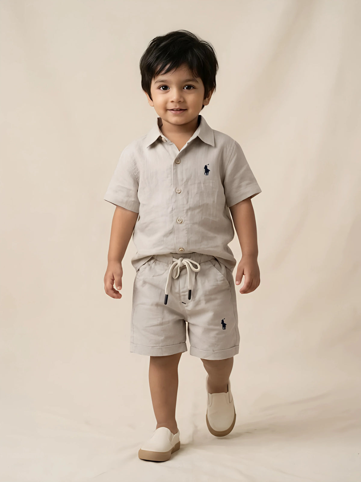 Cream casual cotton boys coordinate set laid flat against a white background.