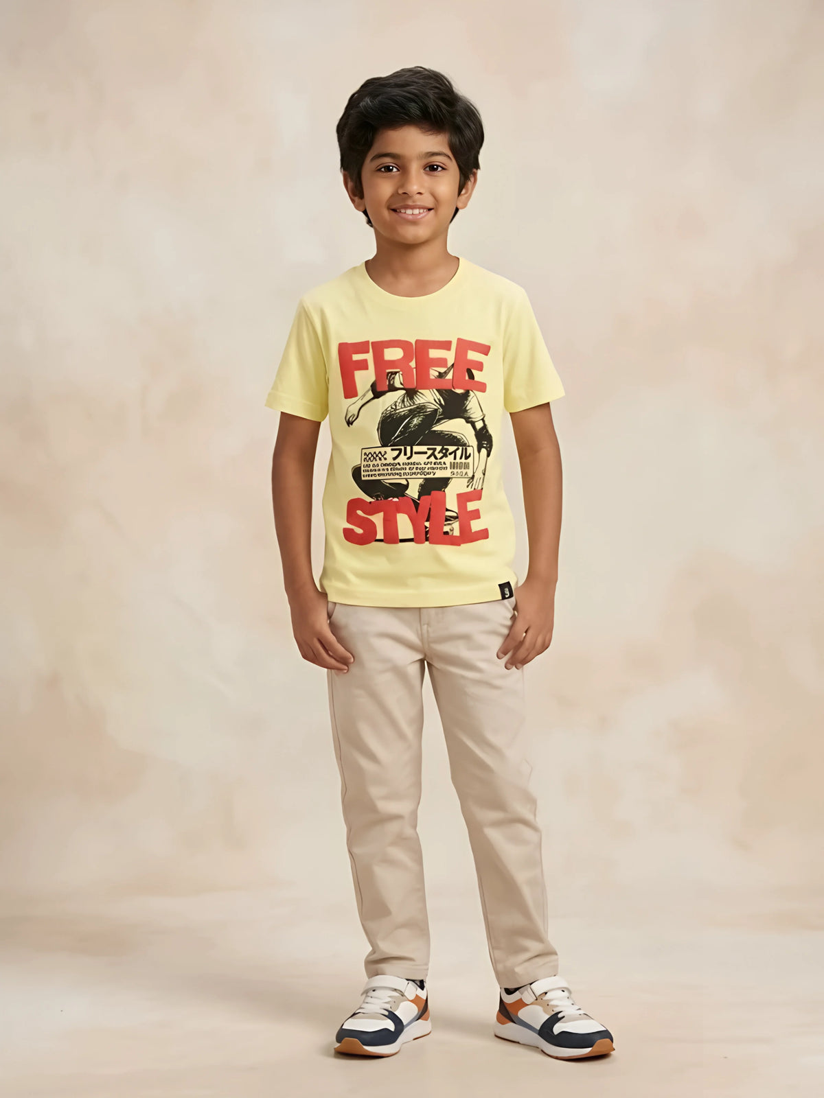 Young boy wearing a light yellow casual round-neck t-shirt with a red freestyle graphic and skateboarder print