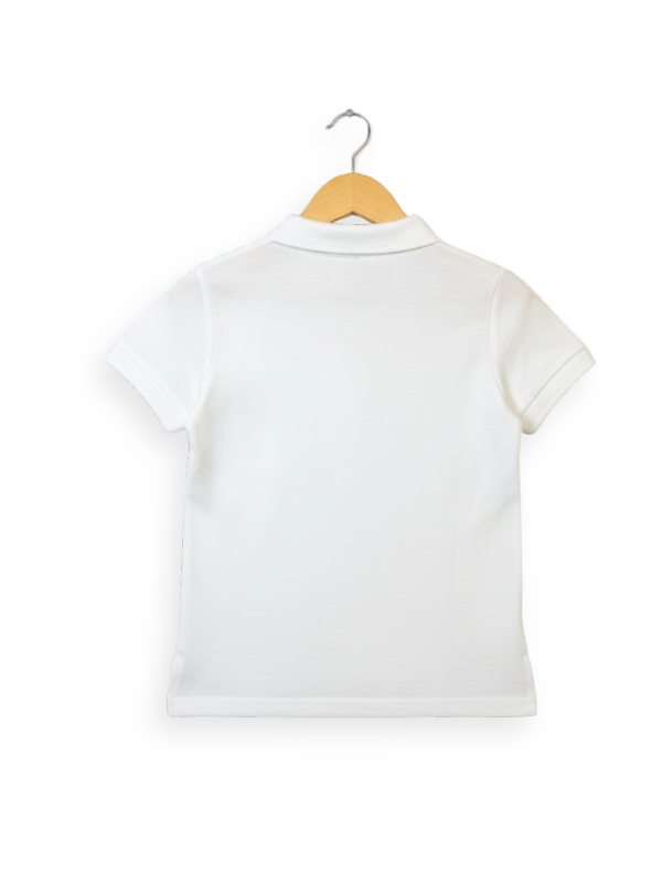Front view of a girls' plain white short-sleeve polo shirt with a collar, two-button placket, and a small embroidered logo on the chest, hanging on a wooden hanger.