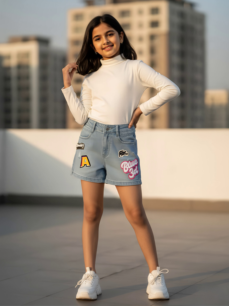 Girls' Light Blue Denim Shorts with Vibrant Graphic Patches and Relaxed Fit.