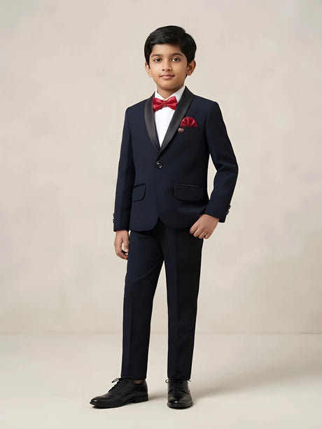 Boys black tuxedo coat suit set with white shirt, red bow tie, and matching red pocket square