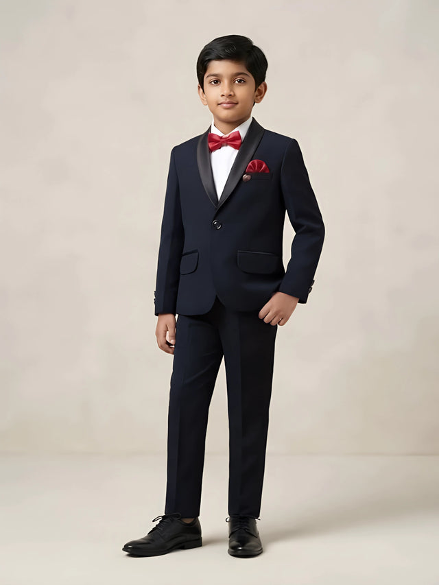 Boys black tuxedo coat suit set with white shirt, red bow tie, and matching red pocket square
