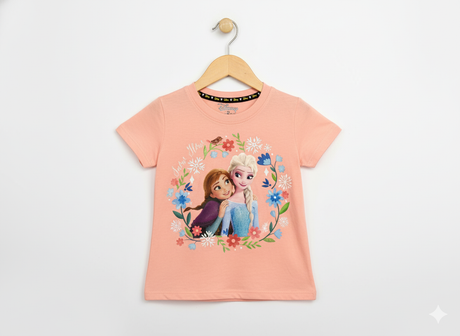 Disney Frozen Anna and Elsa hugging graphic print inside a colorful floral wreath on a peach/coral girls' short-sleeve T-shirt hanging on a wooden hanger against a white background.