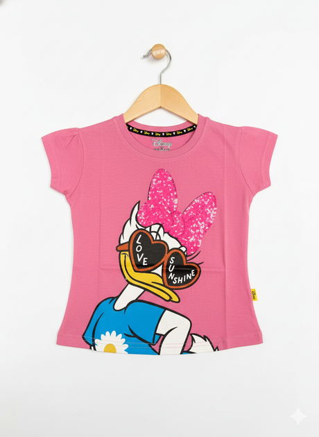 Disney Daisy Duck graphic print wearing heart-shaped sunglasses and a pink glitter bow on a bright pink girls' short-sleeve T-shirt hanging on a wooden hanger against a white background.