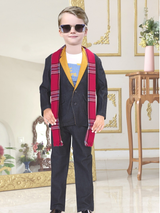 Full-length view of a stylish young boy wearing dark sunglasses, a dark blue suit with a yellow-gold contrast lapel, and a long red and blue plaid scarf.