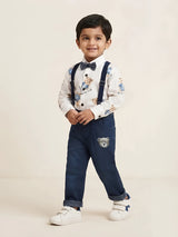 Young boy wearing a white full-sleeve shirt with teddy bear prints, a bow tie, navy suspenders, and dark blue denim trousers