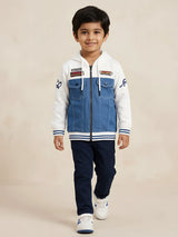 Boys white colorblock hooded jacket with denim style panel and racing patches.