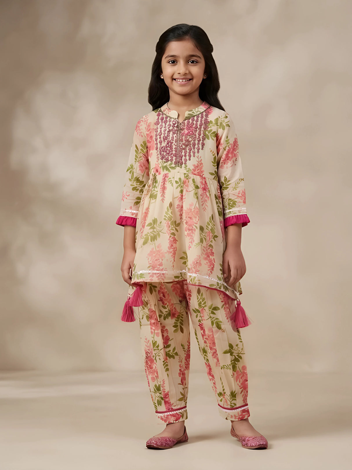 Young girl wearing a pink floral printed kurti and matching patiyala pants ethnic set