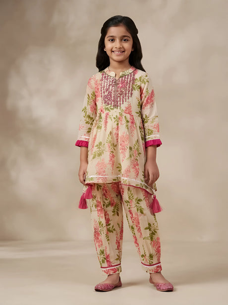 Young girl wearing a pink floral printed kurti and matching patiyala pants ethnic set