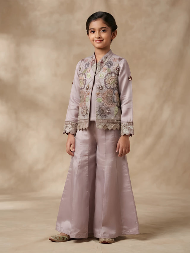 Girls purple embroidered kurta pajama set with matching jacket and pleated pants.