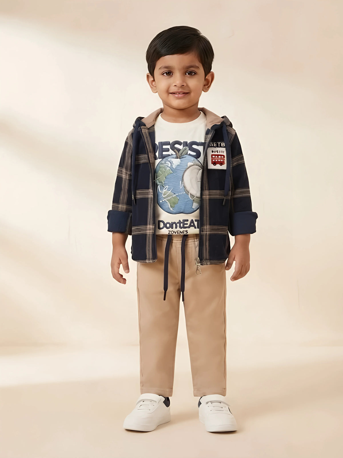 Boys wearing a black plaid hooded jacket layered over a graphic t-shirt with beige trousers