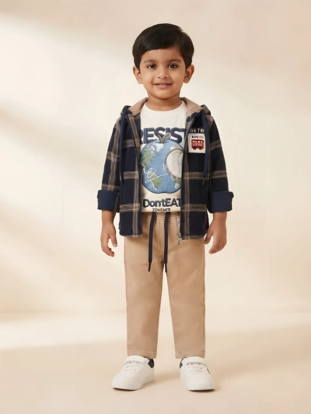 Boys wearing a black plaid hooded jacket layered over a graphic t-shirt with beige trousers