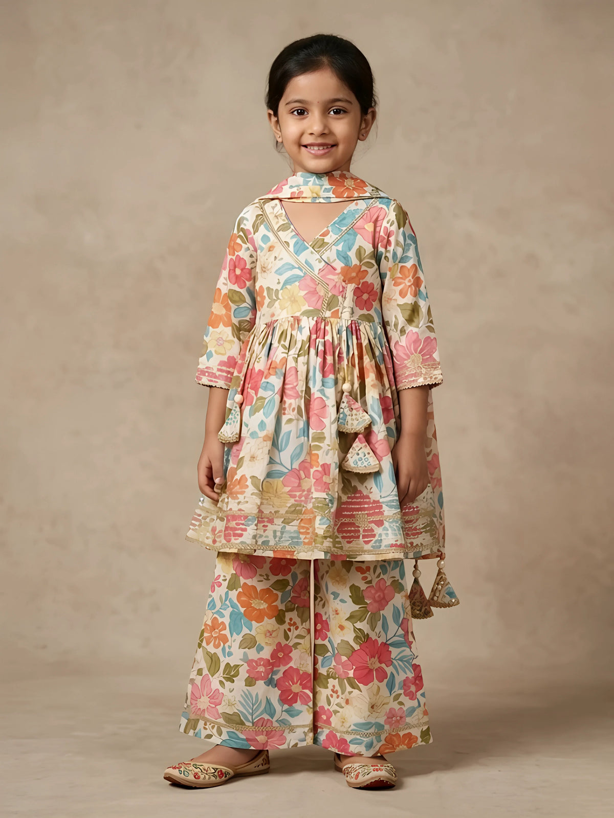 Young girl wearing a cream floral printed Angrakha style tunic with matching wide-leg sharara pants and dupatta