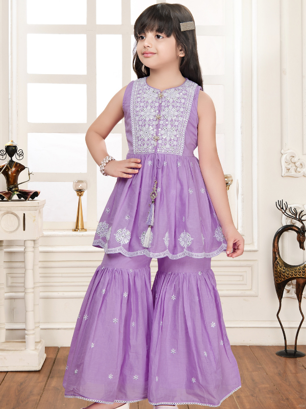 Young girl wearing a sleeveless, lavender purple peplum top with white embroidery on the yoke and hem, paired with matching wide-leg tiered sharara pants, giving a look similar to Chikankari work.