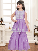 Young girl wearing a sleeveless, lavender purple peplum top with white embroidery on the yoke and hem, paired with matching wide-leg tiered sharara pants, giving a look similar to Chikankari work.