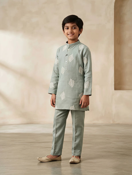 Boy wearing a sage green full sleeve leaf printed kurta set with mandarin collar and matching trousers