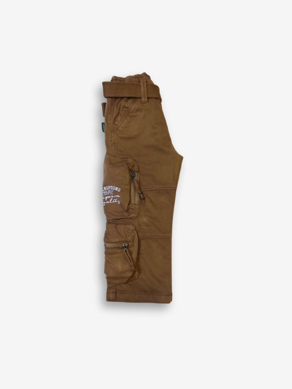 Boys' rustic brown cargo pants with many zippered side pockets, a matching web belt, and cuffed or slightly cropped leg openings.

Export to Sheets