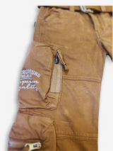 Boys' rustic brown cargo pants with many zippered side pockets, a matching web belt, and cuffed or slightly cropped leg openings.

Export to Sheets
