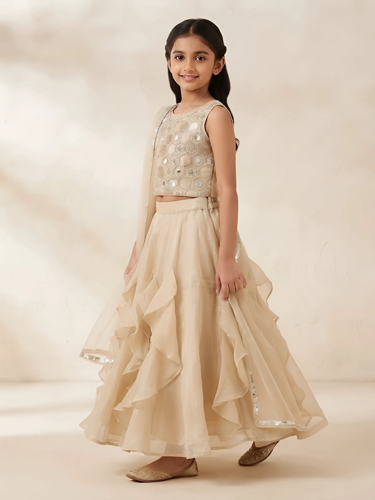 Gold mirror work embellished top with ruffled lehenga skirt and matching dupatta for girls.