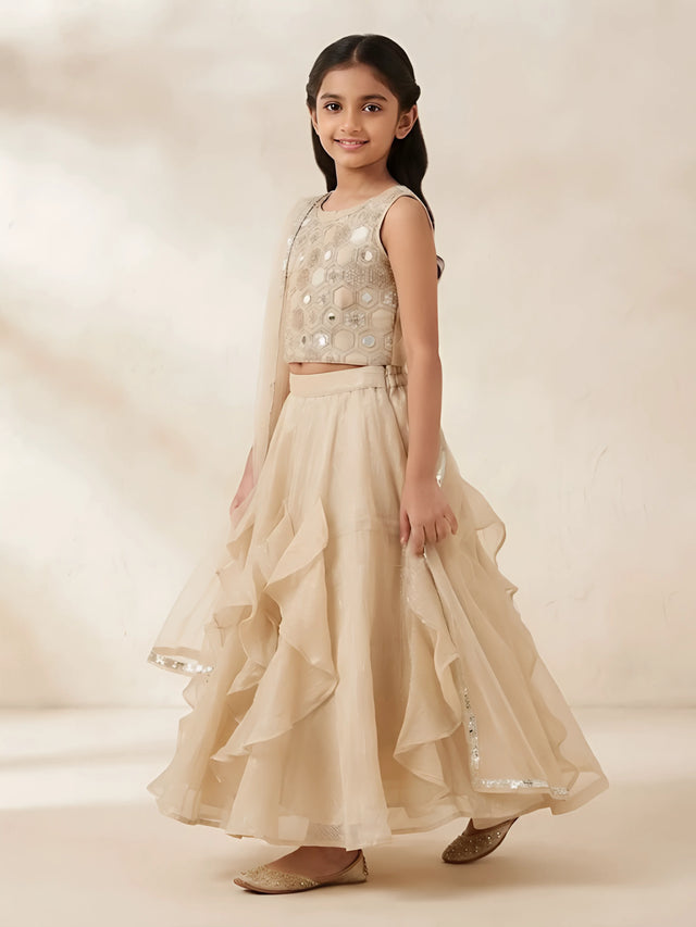 Gold mirror work embellished top with ruffled lehenga skirt and matching dupatta for girls.