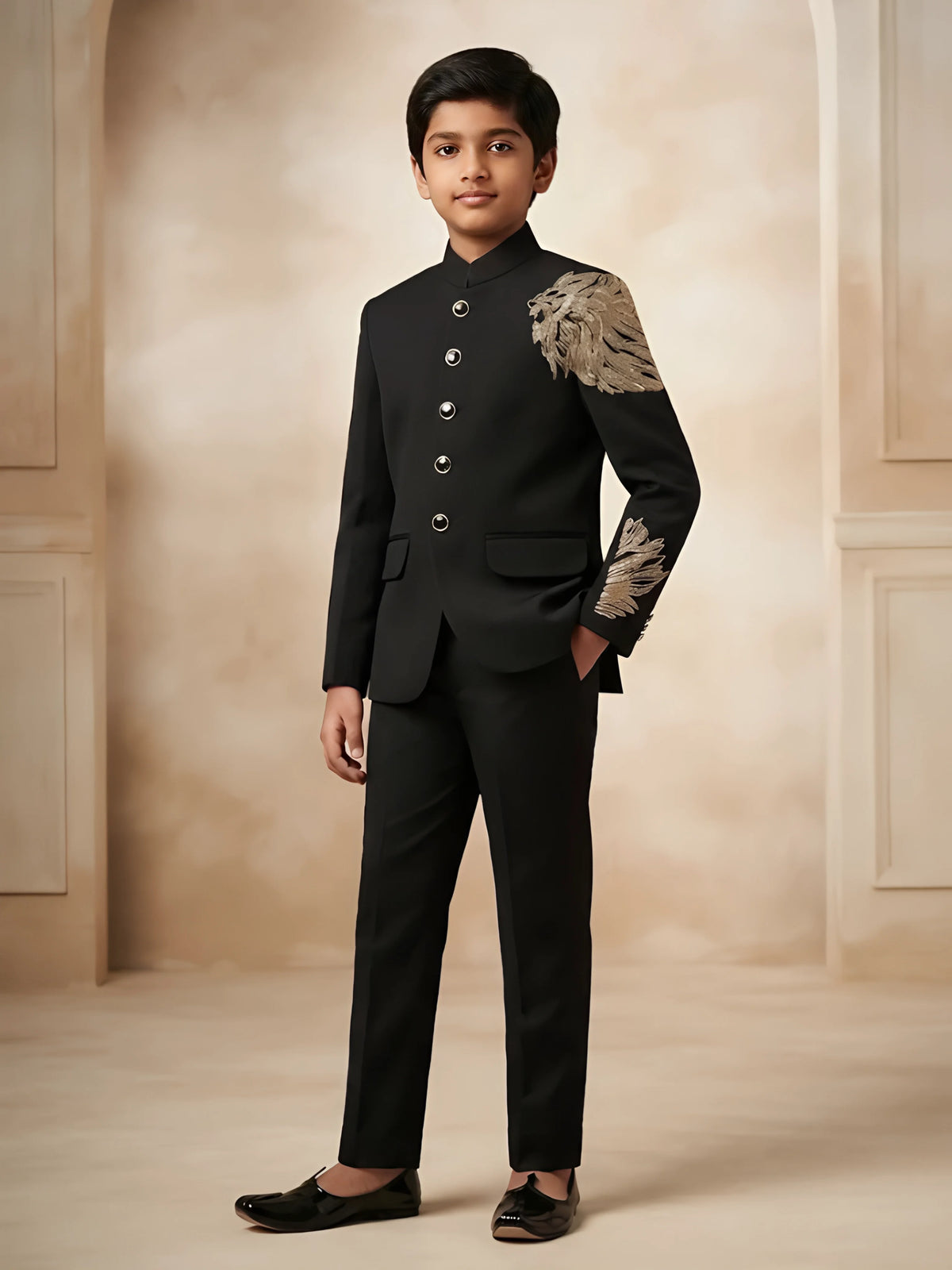 Boys black Jodhpuri bandhgala suit set with gold lion embroidery on shoulder.