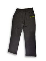 Boys' dark charcoal grey knit or fleece track pants with an elastic waist, pockets, and neon yellow "TENNIS" and tennis ball graphics on the legs.

Export to Sheets