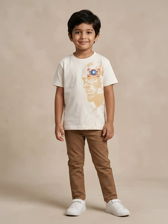 Cream cotton graphic print t-shirt for kids casual wear laid flat on a white background.