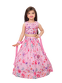 A young girl modeling a beautiful pink lehenga choli set with a sequin-embroidered crop top and a flared skirt featuring a bright, multi-color floral watercolor print, holding a matching pink dupatta.
