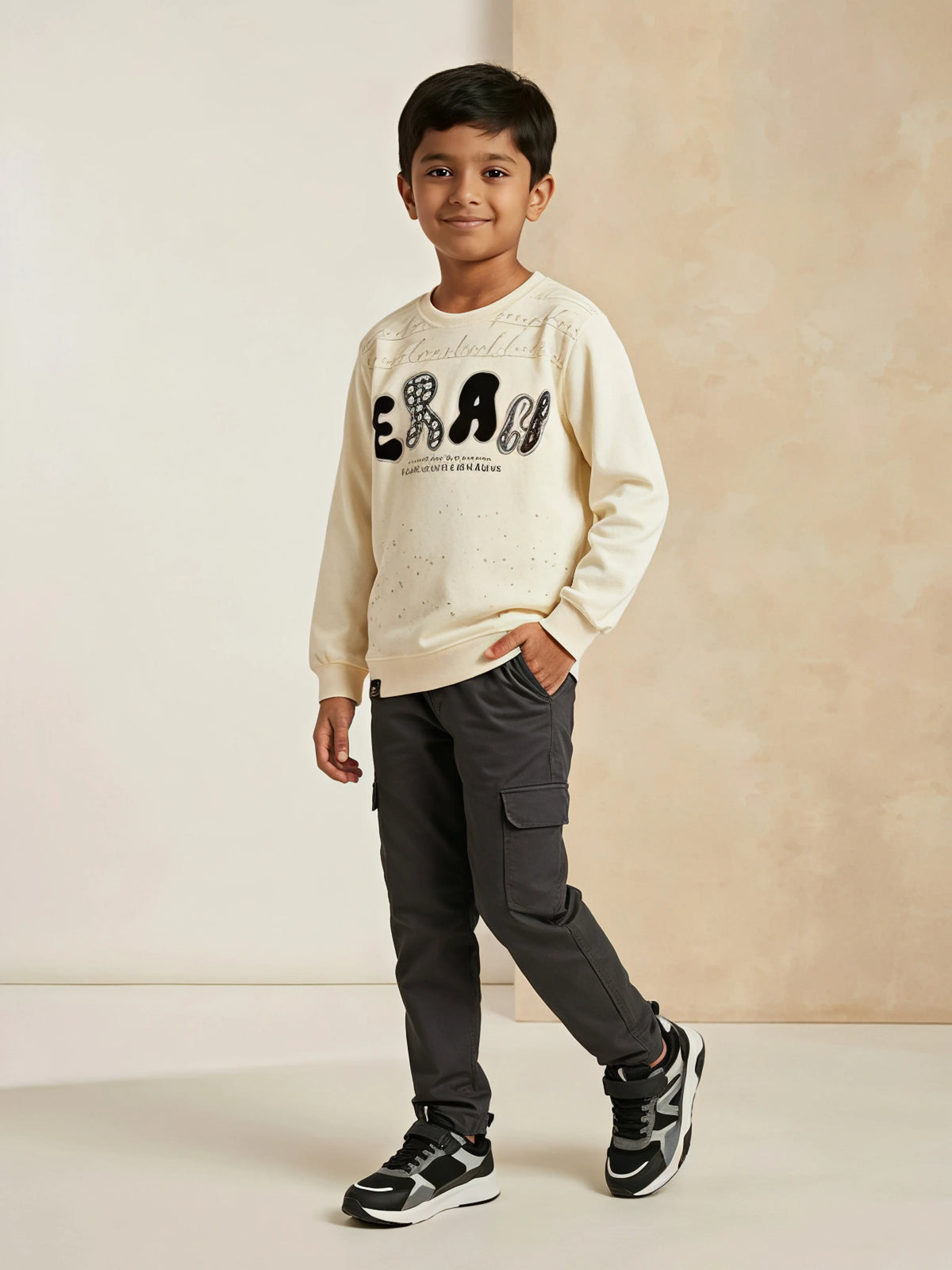Cream graphic print t-shirt for boys displayed on a neutral background
