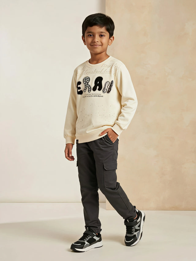Cream graphic print t-shirt for boys displayed on a neutral background