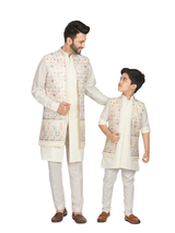 Young boy modeling a long-sleeve, solid cream/off-white kurta with a Mandarin collar, paired with matching traditional pajama pants.