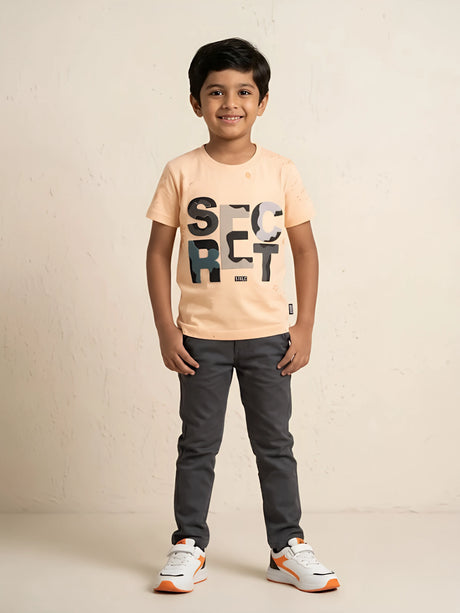 Peach graphic print casual t-shirt for boys displayed flat on a white background