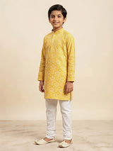 Yellow floral print kurta pajama set for boys with white pants.