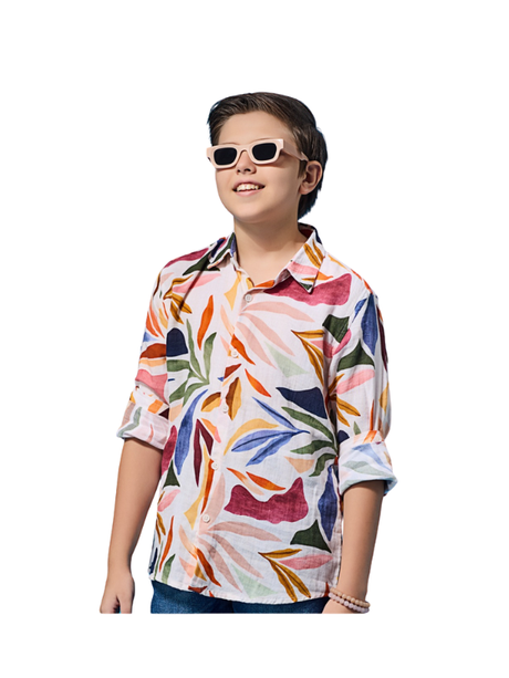 White boys' long-sleeve collared shirt with a colorful abstract tropical leaf print in red, blue, and orange, shown worn with the sleeves rolled up.