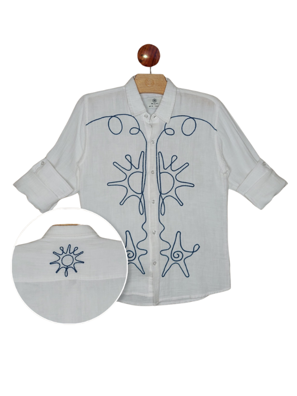 Boys' white long-sleeve shirt with sleeves rolled up, featuring bold navy blue abstract sun and wave embroidery down the front placket. An inset shows a small matching sun embroidery on the back collar.