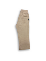 Boys' cream or pale khaki casual trousers with a comfortable elastic waistband, straight leg, and a thick, multicolored contrast rope drawstring.