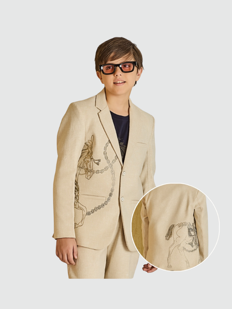 Cream/light beige boys' two-button blazer with a notch lapel, featuring a subtle sketched print of a horse and chain on the front and back.