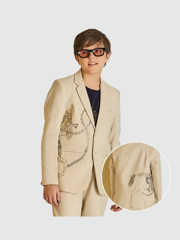 Cream/light beige boys' two-button blazer with a notch lapel, featuring a subtle sketched print of a horse and chain on the front and back.