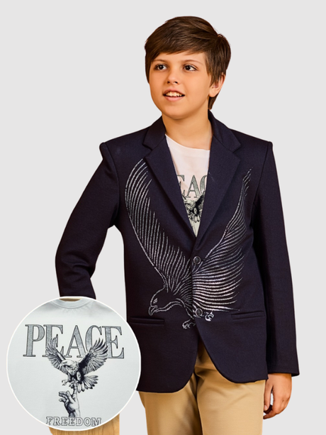 Young boy wearing a navy blue blazer with a large, silvery/gray eagle wing graphic on the chest, styled over a white 'Peace Freedom' graphic t-shirt.