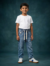 Young boy wearing blue elastic waistband denim jeans with drawstrings and a white t-shirt