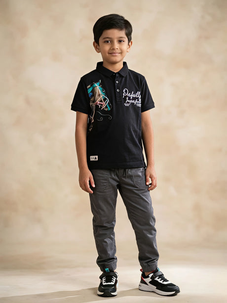 Black polo t-shirt for boys with horse print and graphic text detail.