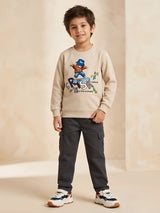 Cream bear graphic print t-shirt for boys with skateboard design.