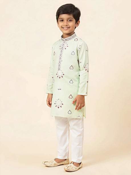 Light green printed kurta pajama set for boys with white trousers.