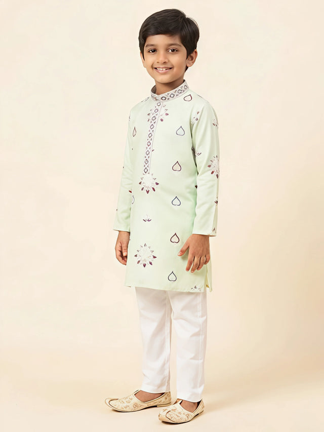 Light green printed kurta pajama set for boys with white trousers.