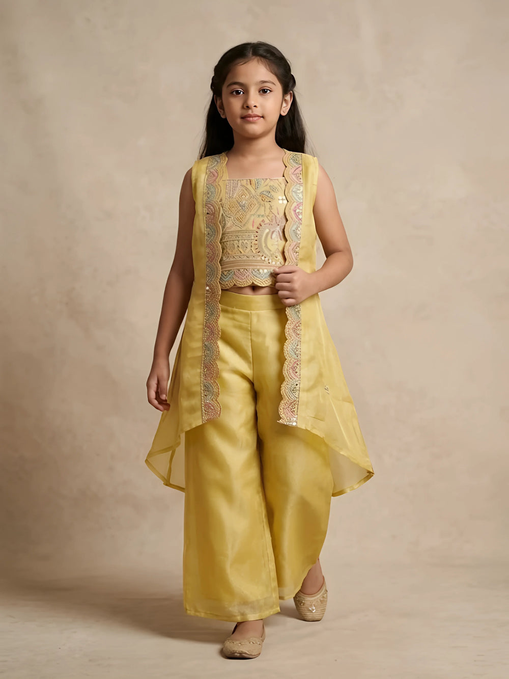 Girls yellow embroidered jacket kurta set with palazzo pants for festive wear.