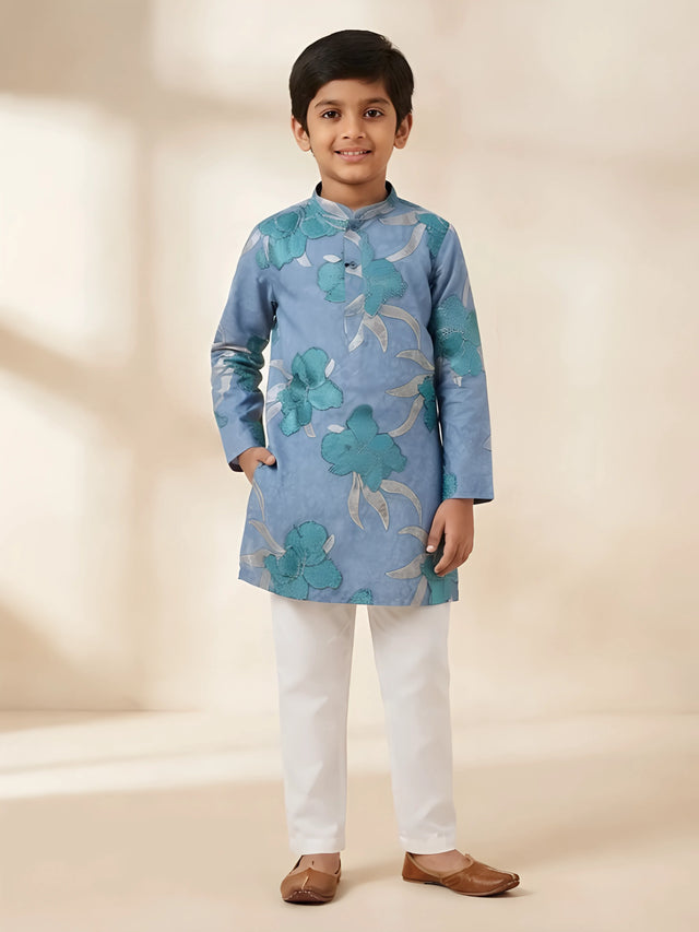Blue floral embroidered kurta pajama set for boys with white pants.
