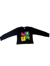 Girls' black long-sleeve top with four colorful patchwork squares and flower appliqués in neon pink, yellow, green, and blue on the chest.

Export to Sheets