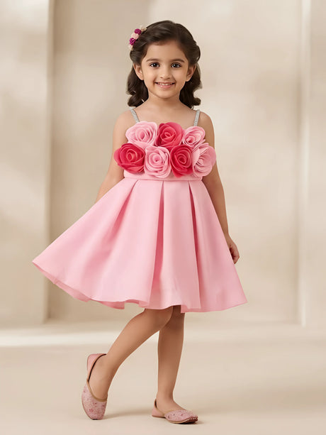 Pink frocks for girls with rose applique detail on the bodice against a white background