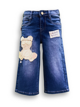 Girls' medium blue wash wide-leg denim jeans with an embroidered teddy bear patch decorated with pearls on the left leg, and a lace patch on the right.

Export to Sheets