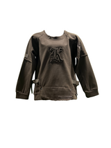 Camel brown/taupe boys' short-sleeve T-shirt with a subtle horizontal texture, featuring a small circular cross/flower emblem graphic on the chest in tan and white